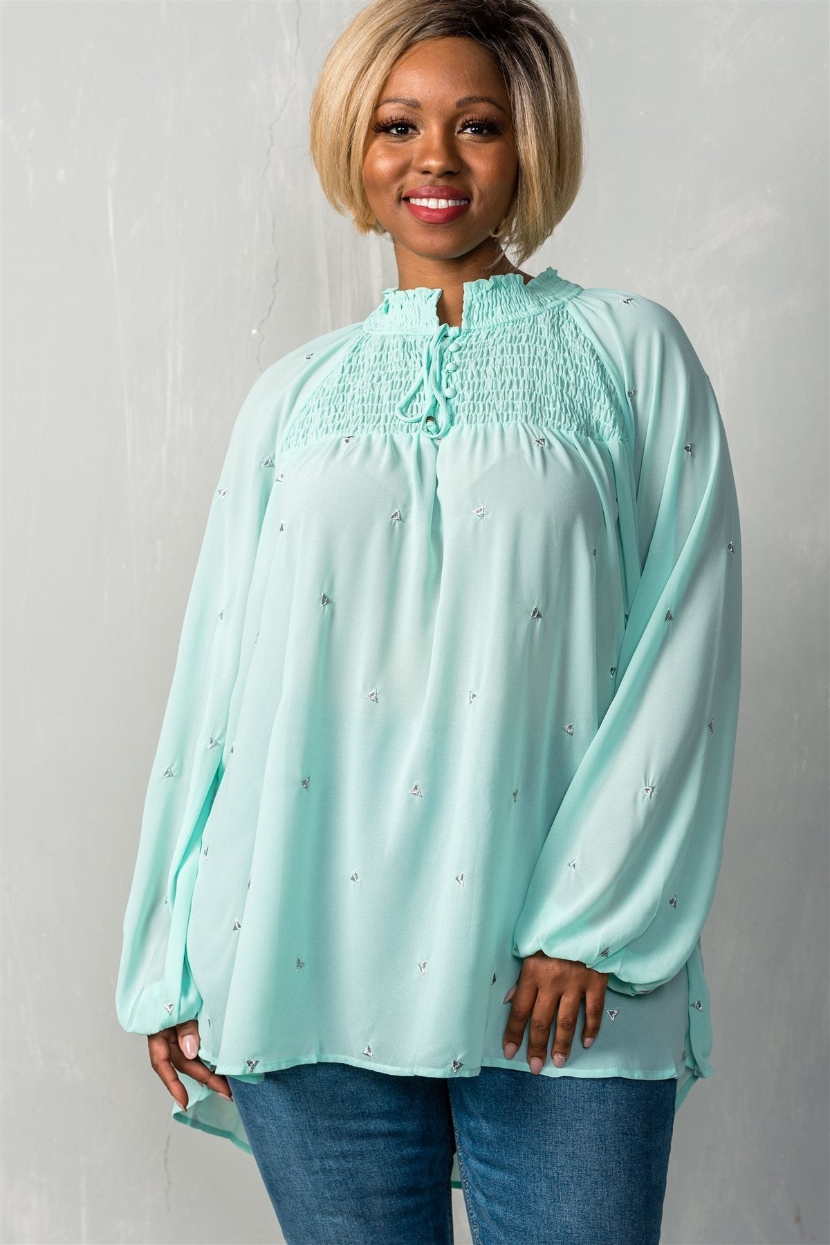 Ladies fashion plus size long sleeve with elastic cuffs, elastic high neckline & elastic chest detail, sheer, triangle metallic detail allover, high-low hem, relaxed fit, button up & self tie closure detail top